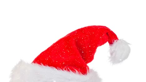 Animation-of-santa-hat-and-over-snow-falling-on-white-background