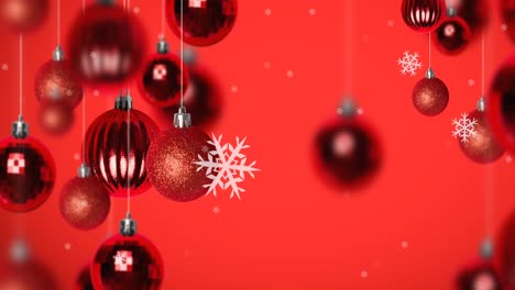 Animation-of-snow-falling-over-christmas-bauble-decorations-on-red-background