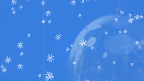Animation-of-snow-falling-over-christmas-bauble-decorations-on-blue-background