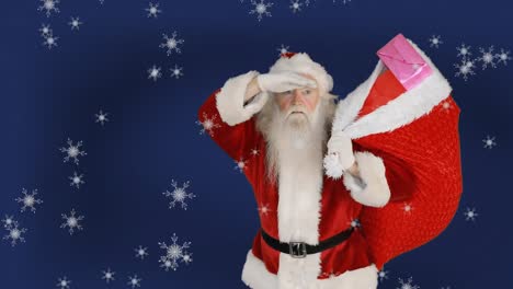 Animation-of-santa-claus-carrying-sack-with-presents,-snow-falling-over-blue-background