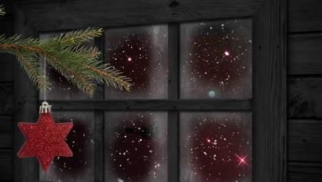 Animation-of-snow-falling-over-christmas-decoration-and-window