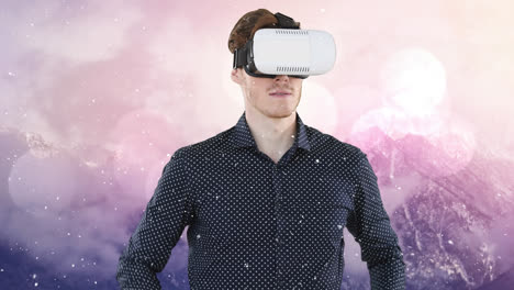 Animation-of-businessman-wearing-vr-headset-over-winter-landscape-and-snow-falling