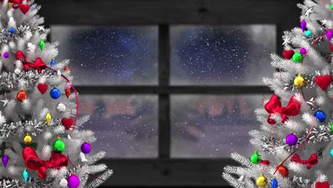 Animation-of-snow-falling-and-christmas-trees-with-winter-scenery-seen-through-window