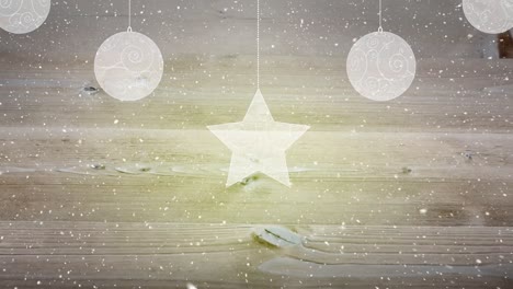 Animation-of-christmas-decorations-over-snow-falling