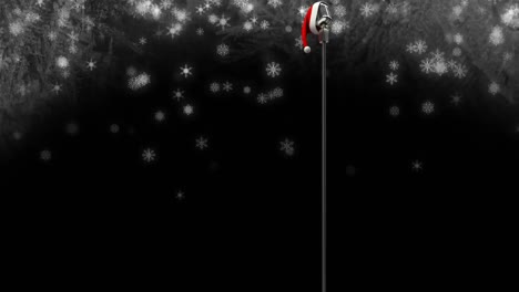 Animation-of-santa-hat-over-vintage-microphone-and-snow-falling-on-black-background