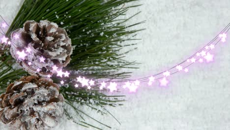 Animation-of-glowing-fairy-lights-and-pinecones-christmas-decorations