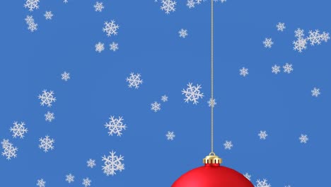 Animation-of-snow-falling-over-red-christmas-bauble-on-blue-background