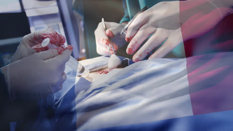 Animation-of-flag-of-france-waving-over-surgeons-in-operating-theatre