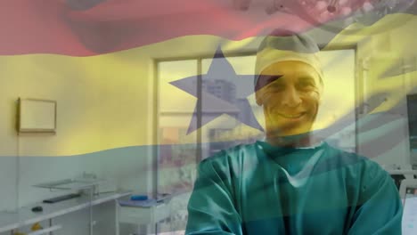 Animation-of-flag-of-ghana-waving-over-anesthesiologist-in-operating-theatre