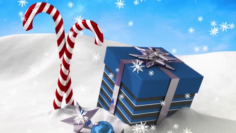 Animation-of-snow-falling-over-christmas-candies-and-present-on-blue-background