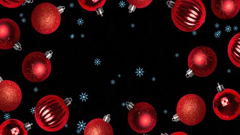 Snow-falling-over-red-baubles-on-black-background