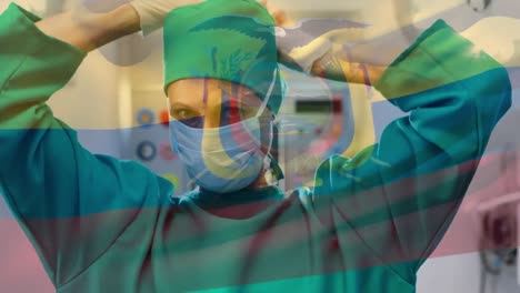 Animation-of-flag-of-ecuador-waving-over-surgeon-in-operating-theatre