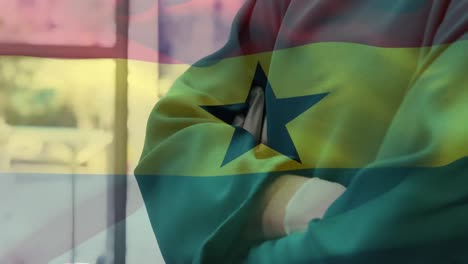 Animation-of-flag-of-ghana-waving-over-surgeon-in-hospital