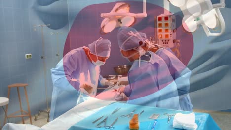 Animation-of-flag-of-japan-over-surgeons-in-operating-theatre