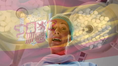 Animation-of-flag-of-spain-waving-over-anesthesiologist-in-operating-theatre