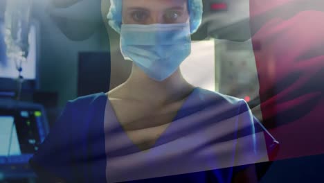 Animation-of-flag-of-france-waving-over-anesthesiologist-in-operating-theatre