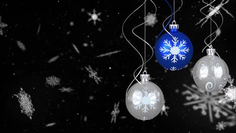 Animation-of-christmas-bubbles-over-snow-on-black-background
