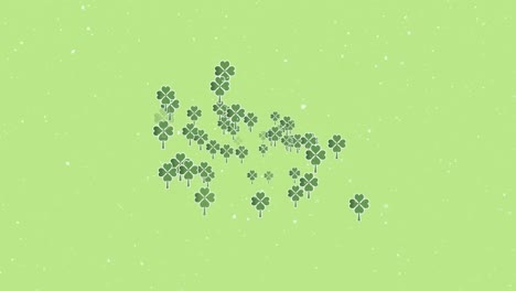 Animation-of-snow-falling-over-clover-leaves-on-green-background