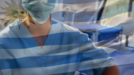 Animation-of-flag-of-uruguay-waving-over-surgeon-in-operating-theatre
