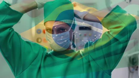 Animation-of-flag-of-brazil-waving-over-surgeon-in-face-masks