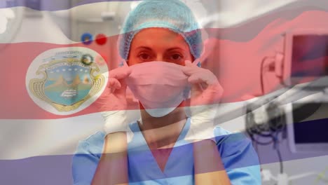 Animation-of-flag-of-south-costa-rica-waving-over-surgeon-in-face-masks