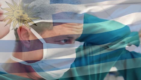 Animation-of-flag-of-uruguay-waving-over-surgeon-in-operating-theatre