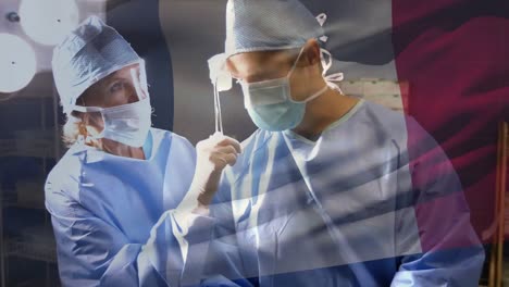 Animation-of-flag-of-belgium-waving-over-surgeons-in-operating-theatre