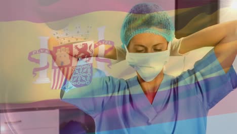Animation-of-flag-of-spain-waving-over-female-surgeon-in-operating-theatre