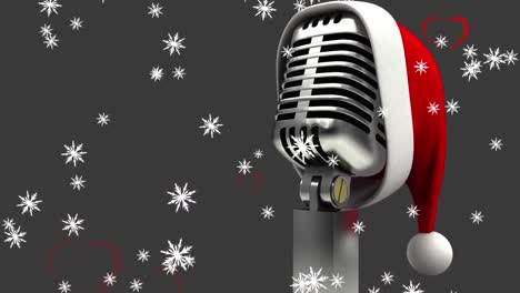 Animation-Eines-Retro-Mikrofons-Mit-Weihnachtsmütze-über-Schnee,-Der-Auf-Grauen-Hintergrund-Fällt