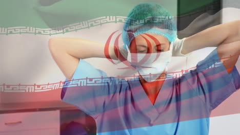 Animation-of-flag-of-iran-waving-over-female-surgeon-in-operating-theatre