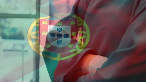 Animation-of-flag-of-portugal-waving-over-surgeon-in-operating-theatre