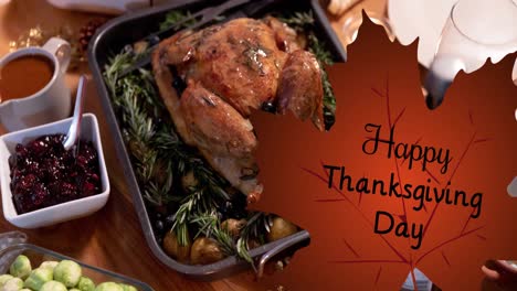 Animation-of-happy-thanksgiving-day-text-on-leaf-over-turkey-and-thanksgiving-meal-setting