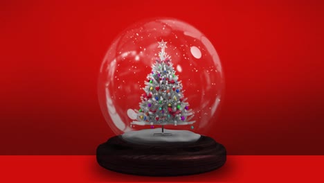 Animación-De-árbol-De-Navidad-En-Bola-De-Nieve-Sobre-Fondo-Rojo.