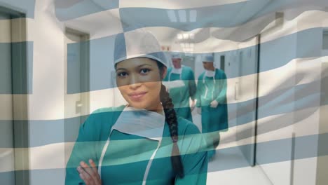Animation-of-flag-of-greece-waving-over-surgeons-in-hospital