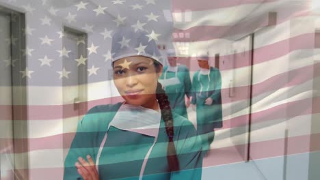 Animation-of-flag-of-usa-waving-over-surgeons-in-hospital