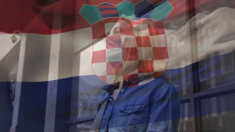 Animation-of-flag-of-croatia-waving-over-caucasian-woman-wearing-face-mask-in-city-street