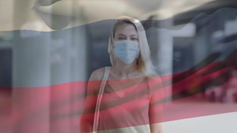 Animation-Der-Flagge-Russlands,-Die-Während-Der-Covid-19-Pandemie-über-Einer-Frau-Mit-Gesichtsmaske-Schwenkt
