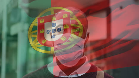 Animation-Der-Flagge-Portugals,-Die-Während-Der-Covid-19-Pandemie-über-Einem-Mann-Mit-Gesichtsmaske-Winkt