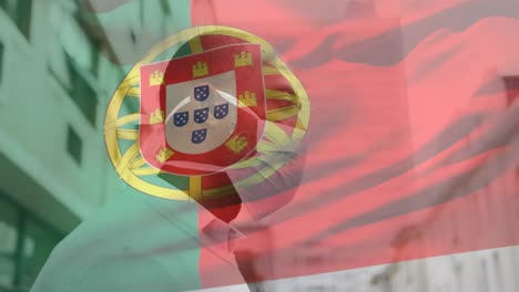 Animation-of-flag-of-portugal-waving-over-latin-man-wearing-face-mask-in-city-street