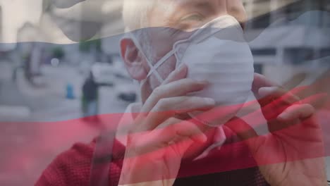 Animation-of-flag-of-russia-waving-over-man-wearing-face-mask-during-covid-19-pandemic