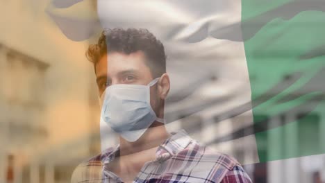Animation-of-flag-of-ivory-coast-waving-over-man-wearing-face-mask-during-covid-19-pandemic