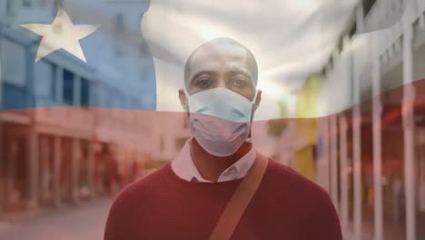 Animation-of-flag-of-chile-waving-over-man-wearing-face-mask-during-covid-19-pandemic