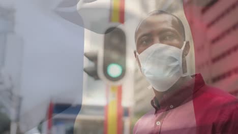Animation-Der-Flagge-Frankreichs,-Die-über-Einem-Afroamerikanischen-Mann-Mit-Gesichtsmaske-In-Der-Stadtstraße-Weht
