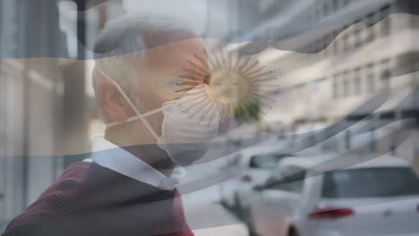 Animation-of-flag-of-argentina-waving-over-man-wearing-face-mask-during-covid-19-pandemic