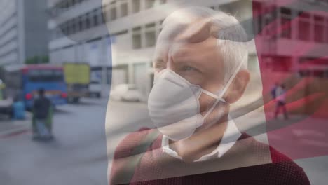 Animation-Der-Flagge-Frankreichs,-Die-Während-Der-Covid-19-Pandemie-über-Einem-Mann-Mit-Gesichtsmaske-Weht