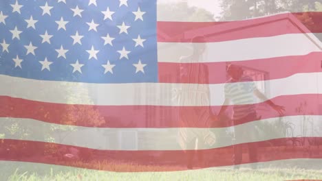 Animation-of-flag-of-usa-waving-over-happy-african-american-mother-and-son-playing-in-garden