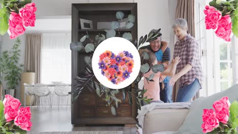 Animation-of-flower-heart-in-round-shape-over-happy-caucasian-grandparents-and-granddaughter