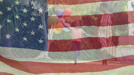 Animation-of-flag-of-usa-waving-over-smiling-african-american-mother-and-daughter-holding-balloons
