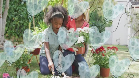 Animation-of-heart-balloons-over-happy-african-american-mother-and-daughter-gardening-plants