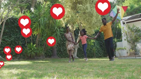 Animation-of-heart-icons-over-happy-african-american-family-in-garden